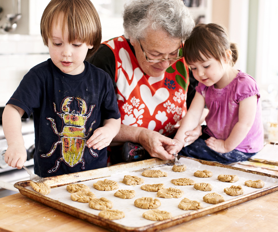 Grandmother and kids making cookies