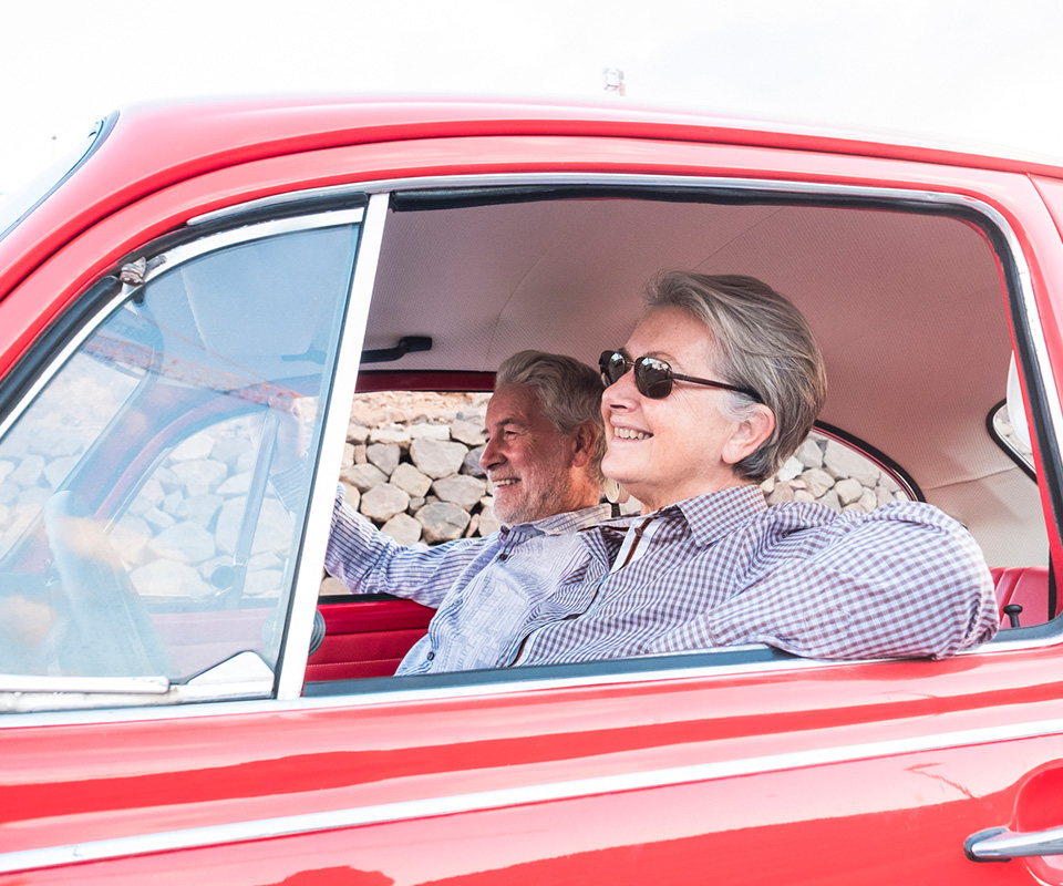 woman-driving-red-car-card