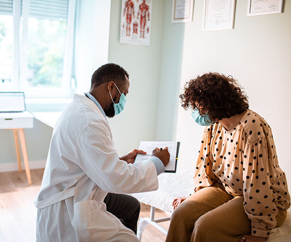Medical Exam doctor doing a medical exam with patient wearing ppe