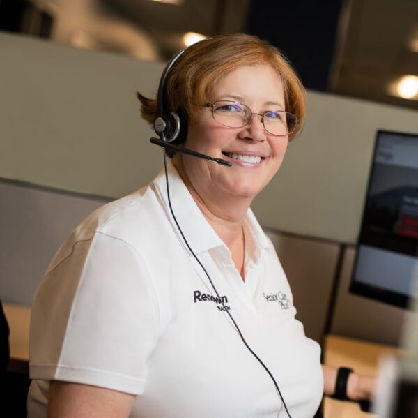 Senior Care Plus representative smiling while assisting customer