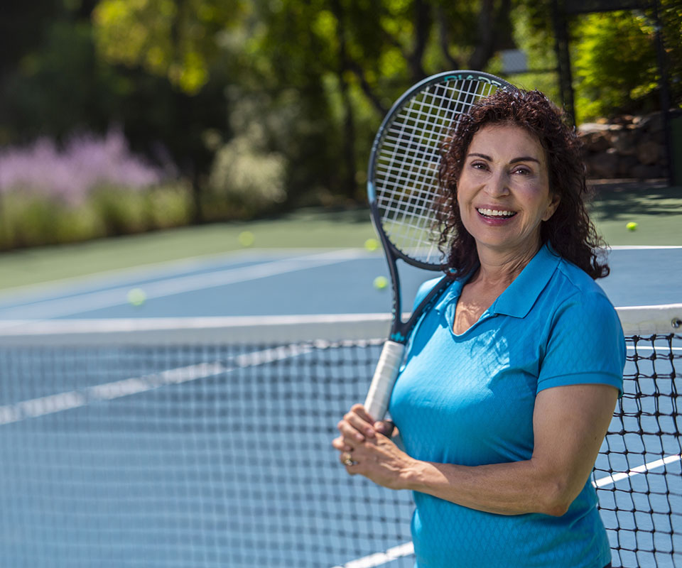 Senior Care Plus Insured senior woman playing tennis