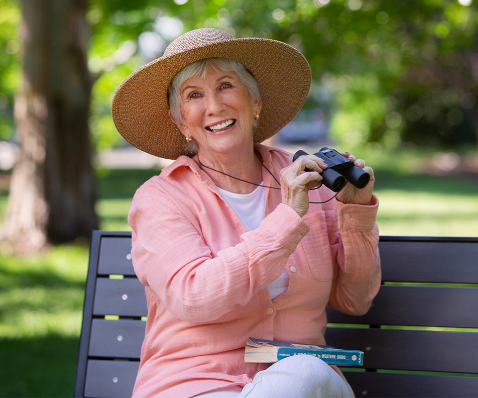 Senior Care Plus Insured Woman bird watching