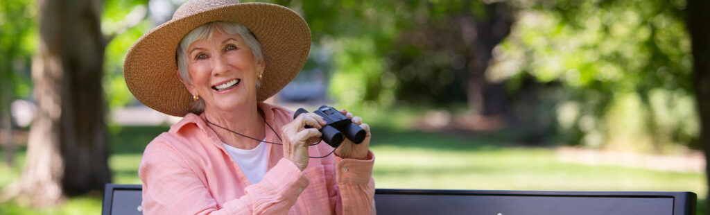 Senior Care Plus Insured Woman bird watching