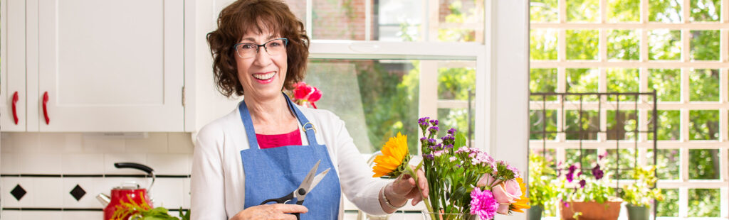 Senior care Plus Insured woman flower arranging