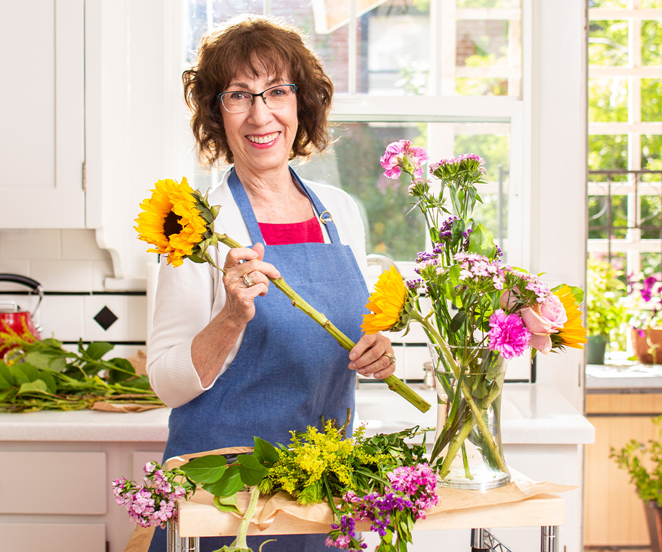Senior care Plus Insured woman flower arranging
