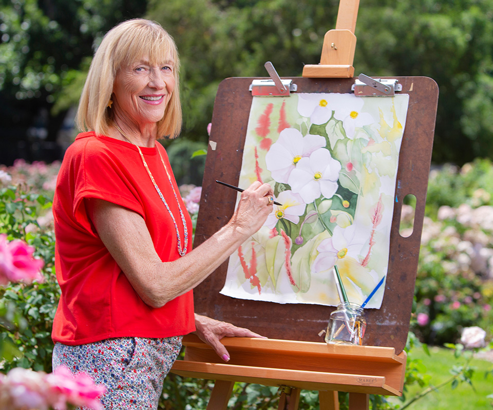 Senior care Plus Insured woman painting flowers